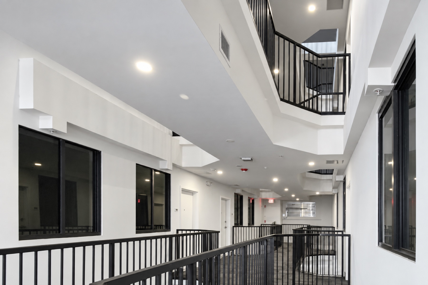 Bright atrium hallway with black railings