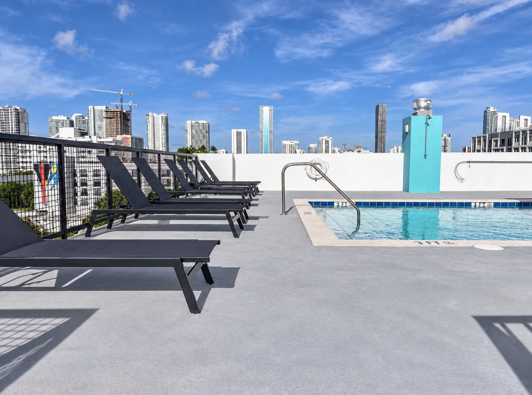 Wynwood Atriums rooftop pool terrace with loungers and Miami skyline